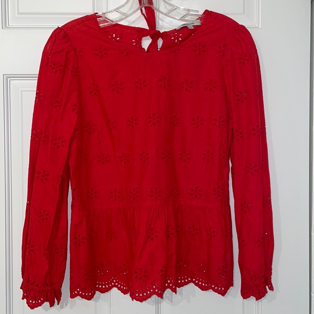 Red top with floral cutouts pattern